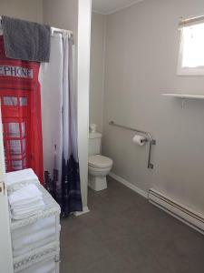 a white bathroom with a toilet and a red telephone booth at Dockside Lake Resort in Monticello +65 photos