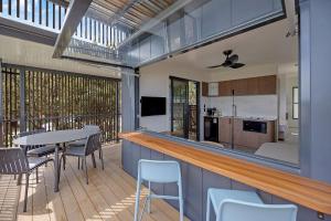 a kitchen and living room with a table and chairs at Reflections Byron Bay - Holiday Park in Byron Bay