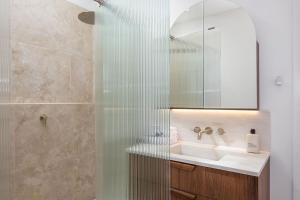 a bathroom with a shower and a sink at Reflections Byron Bay - Holiday Park in Byron Bay +128 photos