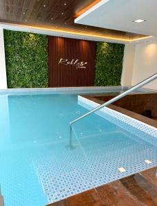 a swimming pool in a building with a plant at Urban Escape Sky View in Cochabamba