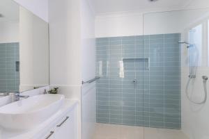 a bathroom with a sink and a glass shower at Lavender & Olive in Myrtleford