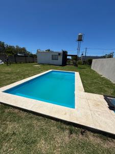 a blue swimming pool in a grassy field at LaMeyacasaquinta in Concepción del Uruguay