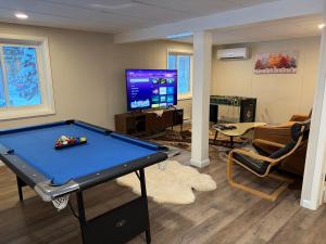 a living room with a pool table and a tv at Evergreen Escapes 4 BR with Game Room, Firepit near Kalahari and Camelback in Long Pond
