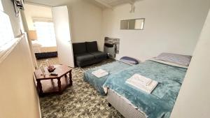 a bedroom with a bed and a chair and a table at Estrellas del Sur in Río Gallegos