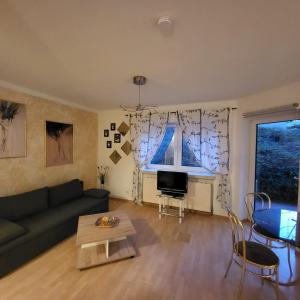 a living room with a couch and a table at Apartment Weimar II in Ulla