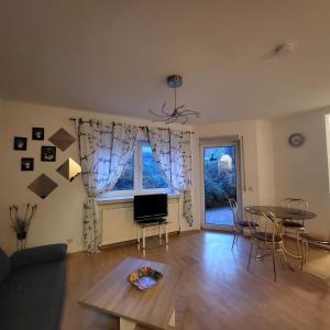 a living room with a table and a dining room at Apartment Weimar II in Ulla