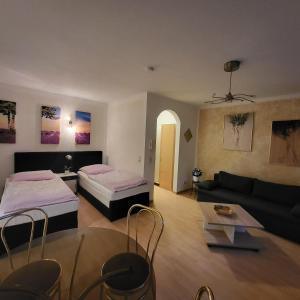 a living room with two beds and a couch at Apartment Weimar II in Ulla