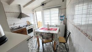 a kitchen with a table with chairs and a refrigerator at Estrellas del Sur in Río Gallegos