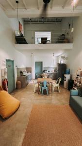 a room with a table and chairs and a kitchen at Testudo Madiha in Matara