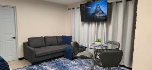 a living room with a couch and a glass table at Los Roires Beach Apartments in Fajardo