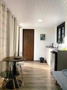 a kitchen with a table in the middle of a room at Villa Cinco Boquete in Alto Boquete +11 photos