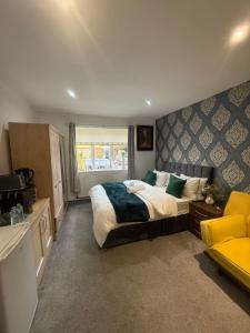 a bedroom with a large bed and a window at Eastern Bridge House in Spinney Hill