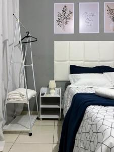 a bedroom with a bed and a ladder and a chair at Royalties Flats in Petrolina