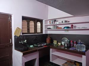 a kitchen with a sink and a counter top at GARDEN villa, Vanasthalipuram in Hyderabad