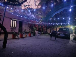 a car parked in front of a building with lights at GARDEN villa, Vanasthalipuram in Hyderabad +8 photos