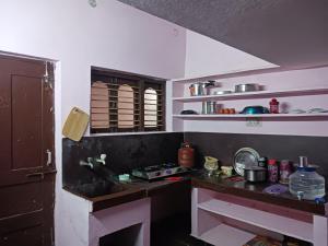 a kitchen with a counter and a sink in it at GARDEN villa, Vanasthalipuram in Hyderabad