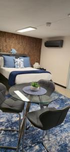 a bedroom with a bed and a table and chairs at Los Roires Beach Apartments in Fajardo