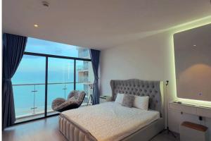 a bedroom with a bed and a large window at CSJ Tower Seaview Apartment -Luxury Near Back Beach Vung Tau City in Vung Tau