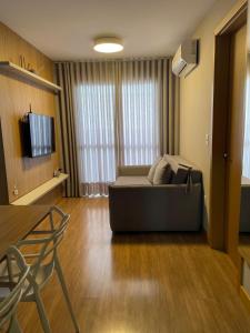 a living room with a couch and a television at Apt 1012 Conforto aconchego e vibe acolhedora in Santa Maria