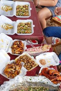 a table with many trays of food on it at HT Hotel in Xuyên Mộc