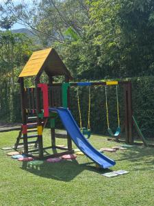 a playground with a slide in the grass at Quinta Las Victorias in Valle de Anton
