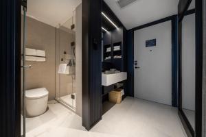 a bathroom with a toilet and a sink at Atour X Hotel Chengdu Qingbaijiang Wanda in Chengdu +35 photos