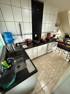 a kitchen with a sink and a counter at Casa temporada Capuba in Serra