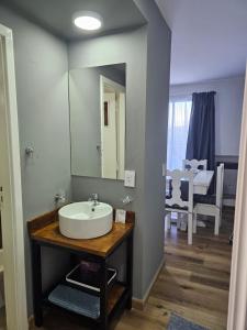 a bathroom with a sink and a mirror at Los Dones Departamentos DAT in San Carlos de Bariloche +132 photos