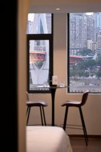 a hospital room with two chairs and a window at Wave Nest 汐宿 in Chongqing