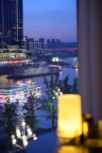 a room with a view of a river at night at Wave Nest 汐宿 in Chongqing