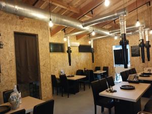 a restaurant with tables and chairs in a room at GuestHouseさがら丸 in Niijimamura