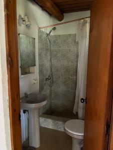 a bathroom with a sink and a shower and a toilet at Carranca TH5 in Costa Azul