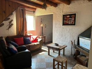 a living room with a couch and a table at Carranca TH5 in Costa Azul +1 photo