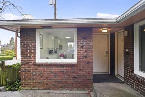 a brick house with a window and a door at King Bed 1BDR Stadium District in Tacoma