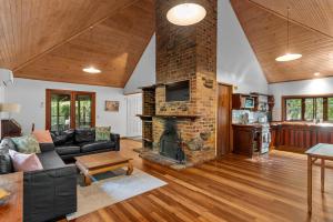 a living room with a couch and a fireplace at Hunchy Hideaway in Montville