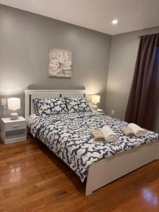 a bedroom with a bed with two pillows on it at Tamuna's Home in Hamilton