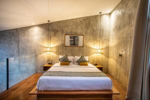 a bedroom with a large bed and two lamps at The Echo Studios HUGE 100m to beach 1 in Badung