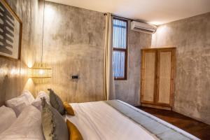 a bedroom with a large white bed with a window at The Echo Studios HUGE 100m to beach 1 in Badung