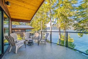 a porch with chairs and a view of the water at Seaside Haven -Hot Tub with Oceanfront View in Port Renfrew +40 photos