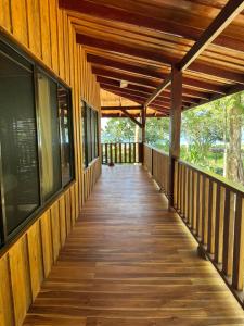 a wooden walkway on a house with a wooden ceiling at Casa Shec- An Oceanfront Jungle Retreat in Drake