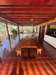 a large wooden table in the middle of a room at Casa Shec- An Oceanfront Jungle Retreat in Drake