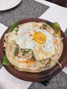 a bowl of food with an egg on top at Seawind in Kannur