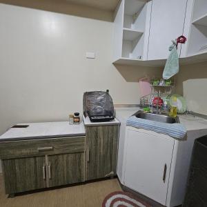 a small kitchen with a sink and a counter at Avida Davao condo Studio type in Davao City +5 photos