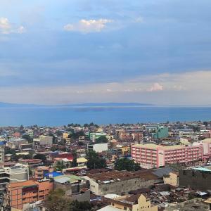 a view of a city with the ocean in the background at Avida Davao condo Studio type in Davao City