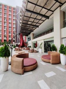 a lobby with wicker chairs and tables in a building at JeeCee Homes in Mactan Lapu-Lapu Cebu in Agus
