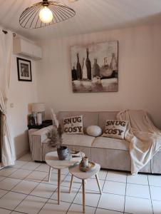 a living room with a couch and a table at Le Roly's in Saint-Saturnin-lès-Avignon