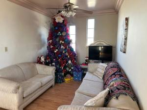 a living room with a christmas tree and a couch at Casa para grupos grandes in Mexicali