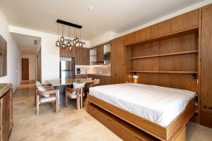 a bedroom with a large bed and a dining room at Beachfront townhouse TH03A in Cruz de Huanacaxtle +23 photos