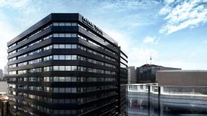 a tall black building with the words suttonbris on it at Nine Tree by Parnas Seoul Myeongdong 1 in Seoul