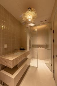 a bathroom with a shower and a sink and a shower stall at Emerald Boutique Hotel Phú Quốc in Phú Quốc +16 photos